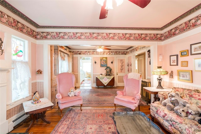 44 Jackson St, Fishkill, NY 12524 - living area featuring crown molding, a ceiling fan, wood finished floors, and a baseboard radiator