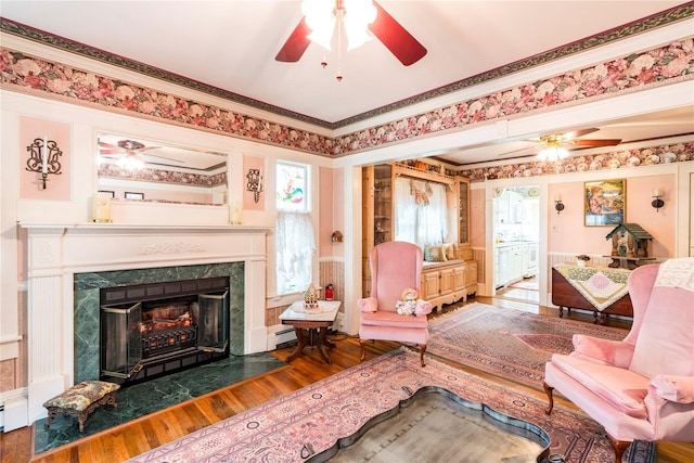 44 Jackson St, Fishkill, NY 12524 - sitting room with crown molding, baseboard heating, a ceiling fan, and wood finished floors