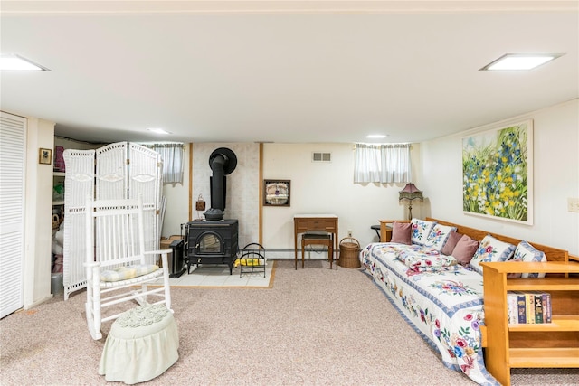 44 Jackson St, Fishkill, NY 12524 - carpeted living area with visible vents and a wood stove