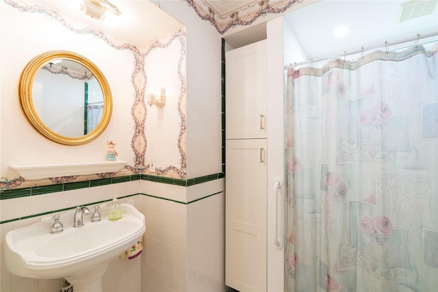 44 Jackson St, Fishkill, NY 12524 - full bath featuring tile walls, a shower with curtain, visible vents, and a sink