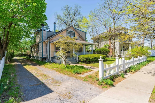 44 Jackson St, Fishkill, NY 12524 - bungalow-style house with a porch, a fenced front yard, driveway, and a chimney