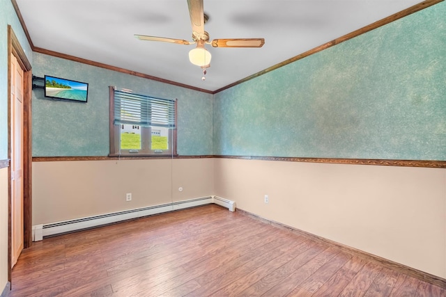 unfurnished room with crown molding, baseboards, ceiling fan, hardwood / wood-style flooring, and a baseboard radiator