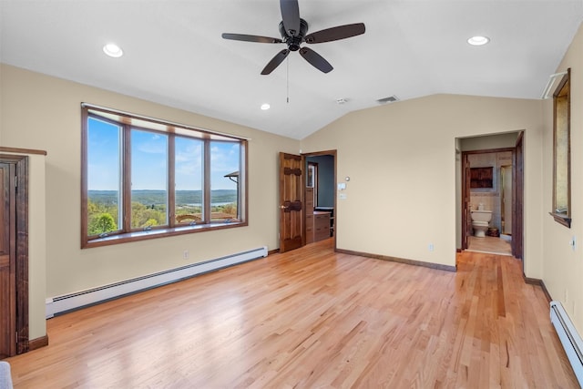 unfurnished living room with light wood-style floors, a baseboard heating unit, lofted ceiling, and visible vents
