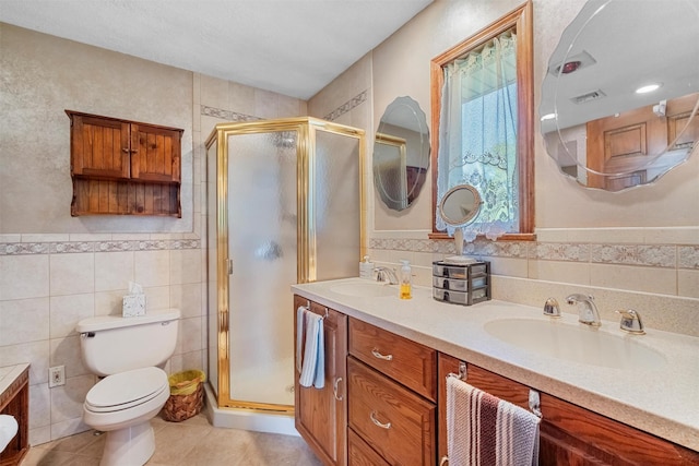 bathroom with a sink, tile walls, and a shower stall