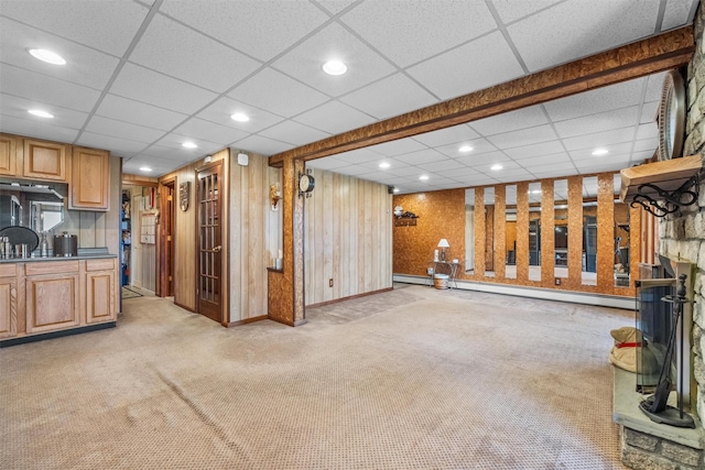 below grade area featuring recessed lighting, light colored carpet, a paneled ceiling, and a baseboard heating unit