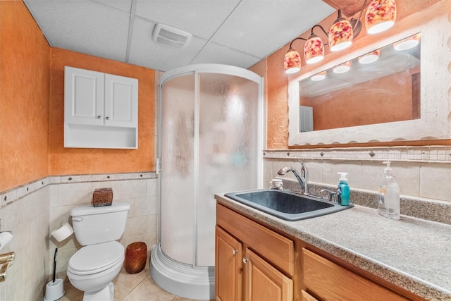 bathroom with tile walls, vanity, tile patterned floors, and visible vents