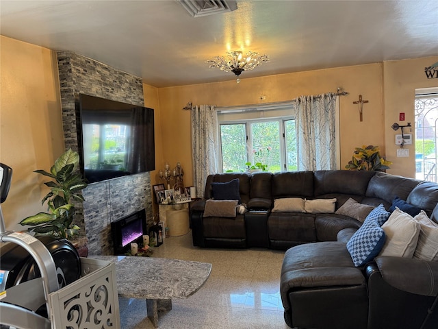 living room with visible vents and a stone fireplace