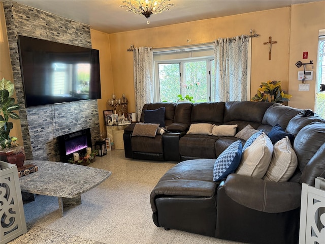 living room with a fireplace and speckled floor