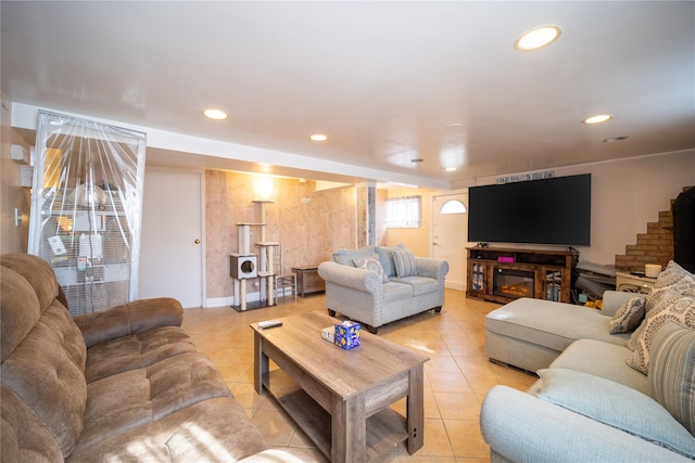 living area with recessed lighting, baseboards, light tile patterned floors, and stairway