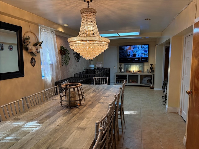 dining area featuring tile patterned floors, an inviting chandelier, and baseboards