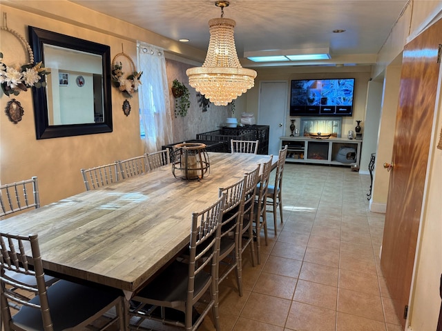 dining space with a chandelier and tile patterned flooring