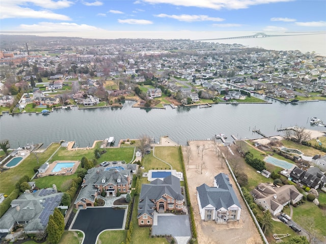 drone / aerial view featuring a water view and a residential view
