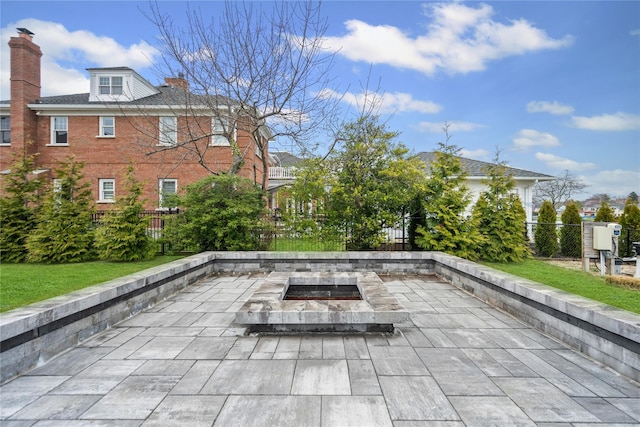 view of patio / terrace with a fire pit and fence