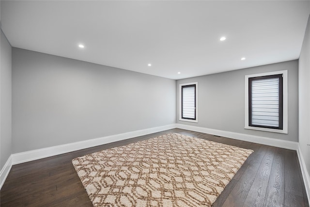 unfurnished room with baseboards, recessed lighting, and dark wood-style floors