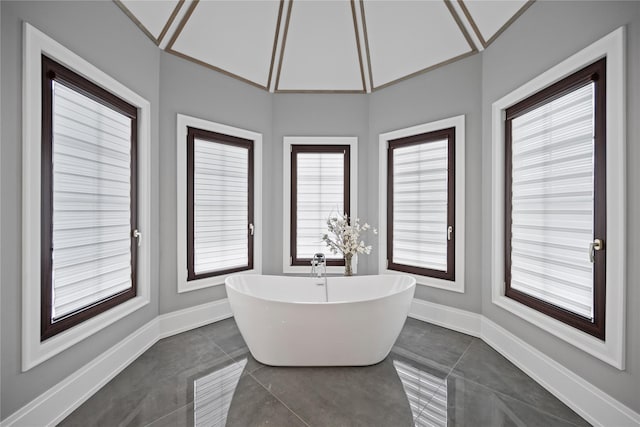 full bathroom with baseboards, a soaking tub, tile patterned floors, and visible vents