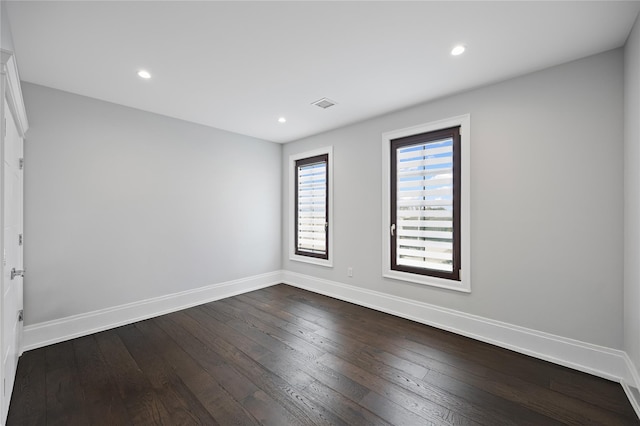 spare room with baseboards, recessed lighting, dark wood-style flooring, and visible vents