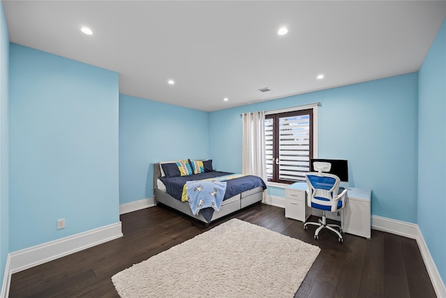 bedroom featuring visible vents, dark wood-style flooring, and baseboards