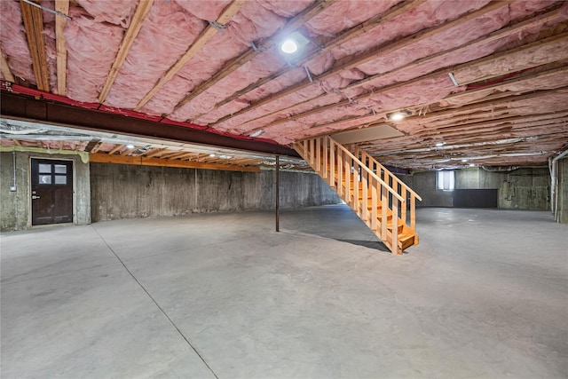 unfinished basement featuring stairs