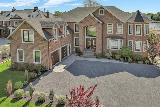 185 Willetts Ln, West Islip, NY 11795 - view of front of home with a garage, brick siding, asphalt driveway, and roof with shingles