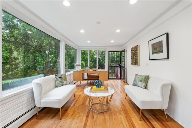 sunroom / solarium featuring a baseboard radiator, recessed lighting, wood finished floors, and ornamental molding