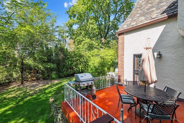 wooden deck with area for grilling, a lawn, and outdoor dining area