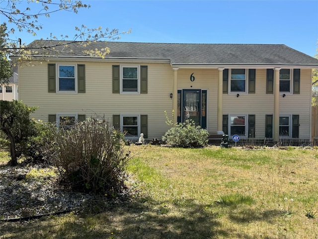 bi-level home with a front lawn