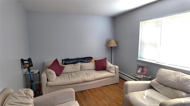 living room with baseboard heating and wood finished floors