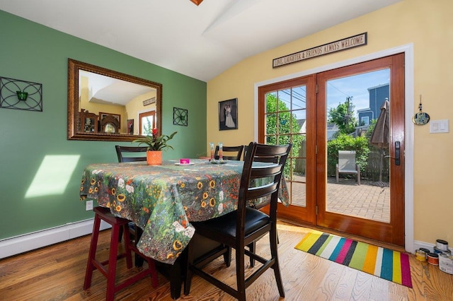 64 Harmon St, Long Beach, NY 11561 - dining room featuring lofted ceiling, wood finished floors, a baseboard radiator, and baseboards