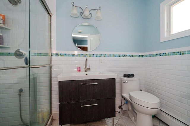 64 Harmon St, Long Beach, NY 11561 - full bath with a baseboard radiator, tile walls, a shower stall, vanity, and toilet