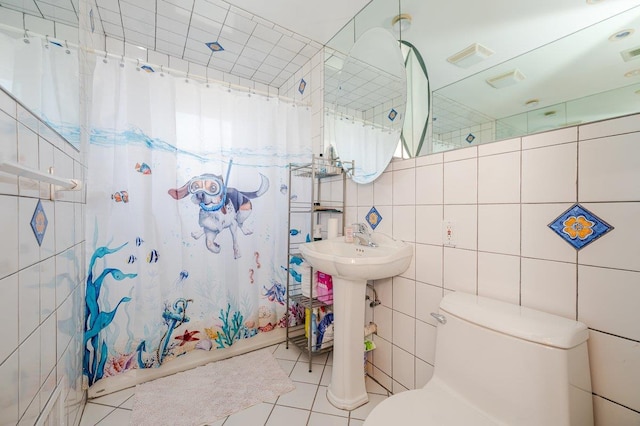 64 Harmon St, Long Beach, NY 11561 - full bathroom with toilet, tile patterned flooring, tile walls, and shower / bathtub combination with curtain