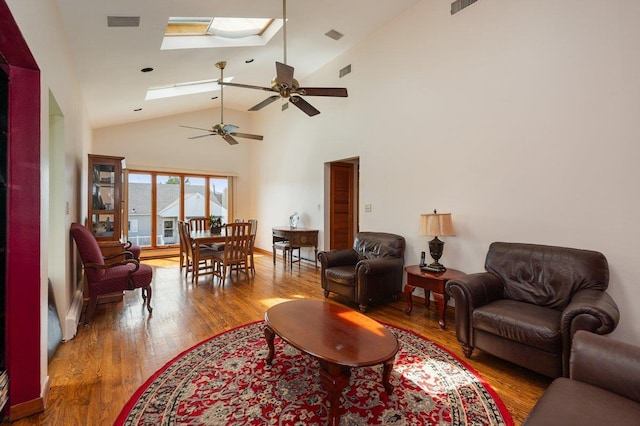 64 Harmon St, Long Beach, NY 11561 - living room featuring ceiling fan, a skylight, wood finished floors, and high vaulted ceiling