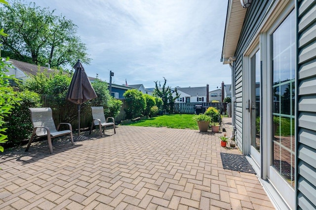 64 Harmon St, Long Beach, NY 11561 - fenced backyard featuring a patio and a residential view
