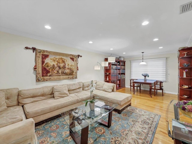living room featuring crown molding, recessed lighting, visible vents, and light wood-style flooring