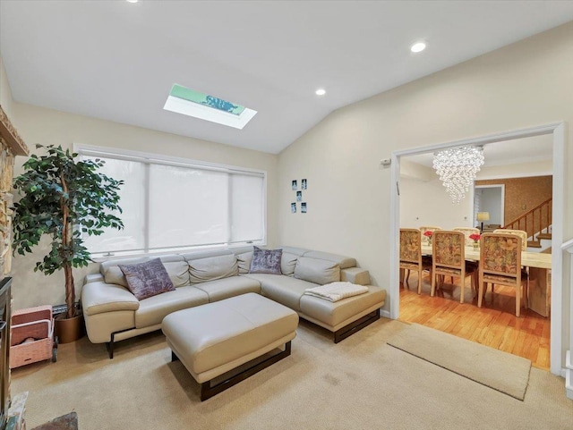 living area with stairs, wood finished floors, lofted ceiling with skylight, recessed lighting, and a chandelier