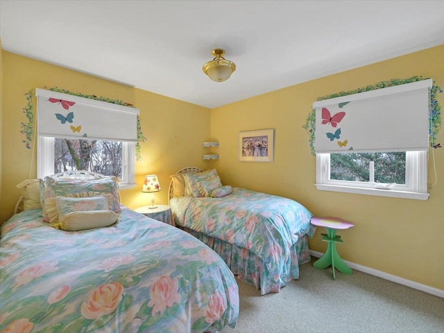 bedroom with carpet floors and baseboards