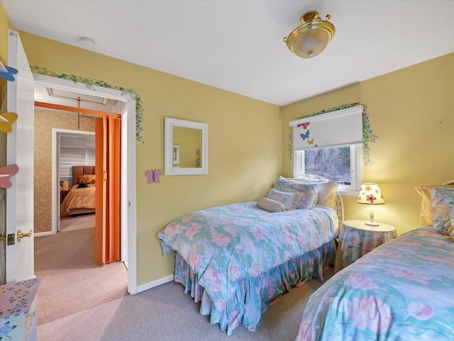 carpeted bedroom featuring baseboards