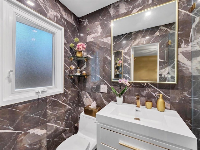 half bathroom with vanity, decorative backsplash, toilet, and tile walls