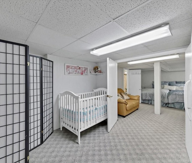 carpeted bedroom featuring a paneled ceiling