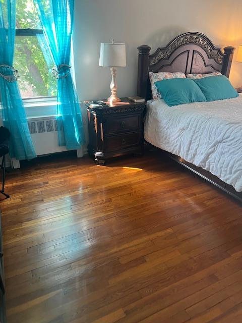 bedroom with dark wood finished floors