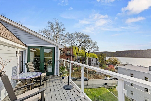 wooden terrace featuring a water view
