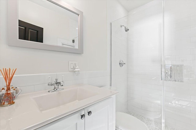 full bathroom featuring vanity, toilet, and a stall shower