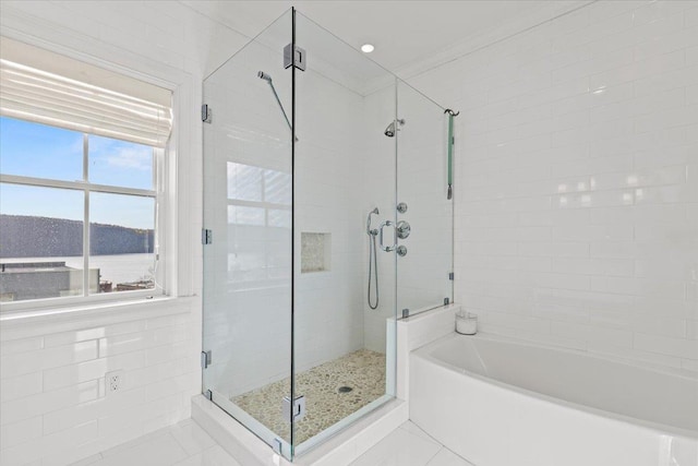 full bathroom featuring a garden tub, tile patterned floors, and a shower stall