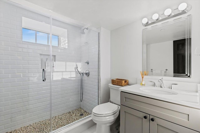 full bathroom with vanity, a stall shower, and toilet