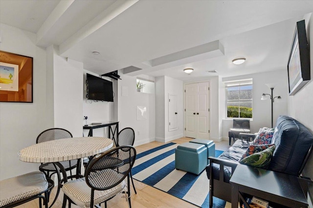 living area with baseboards and light wood finished floors