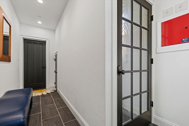 doorway with baseboards and recessed lighting