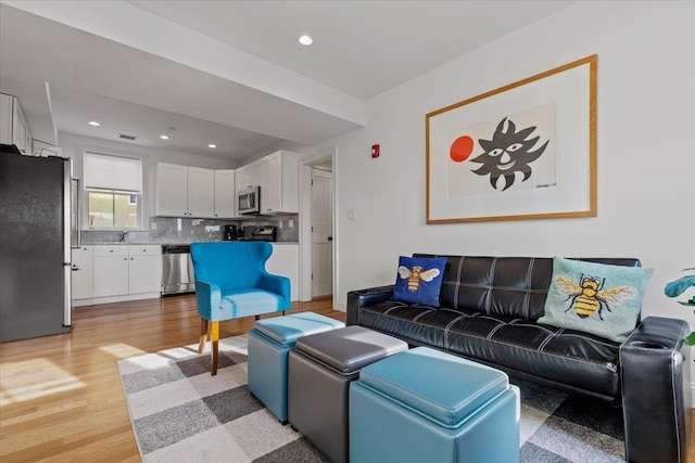 living room featuring recessed lighting and light wood-style flooring