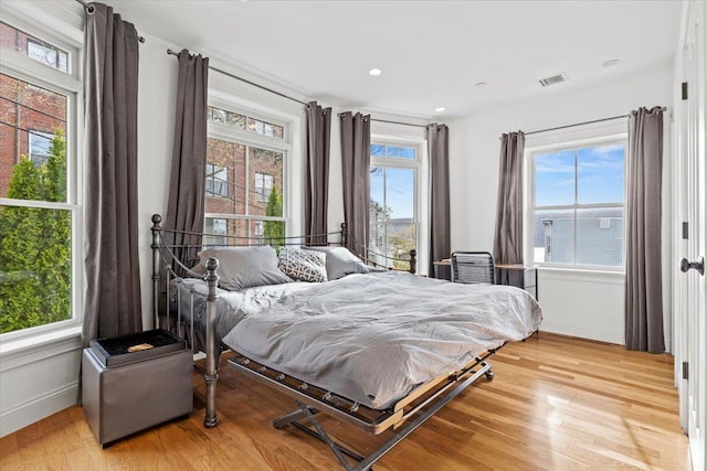 bedroom with recessed lighting, baseboards, visible vents, and light wood finished floors