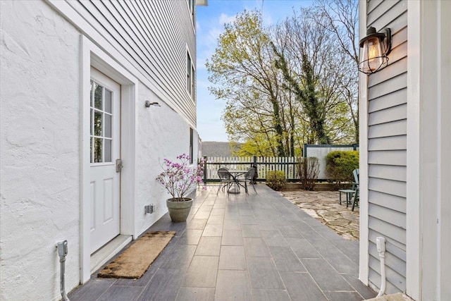 view of patio featuring fence and outdoor dining space