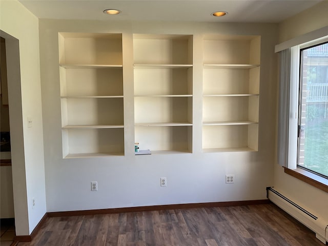 interior space featuring dark wood-type flooring, recessed lighting, and a baseboard heating unit
