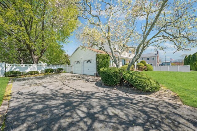view of patio featuring fence and driveway